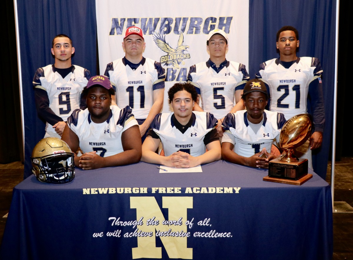 Eight students who signed to play football in college.