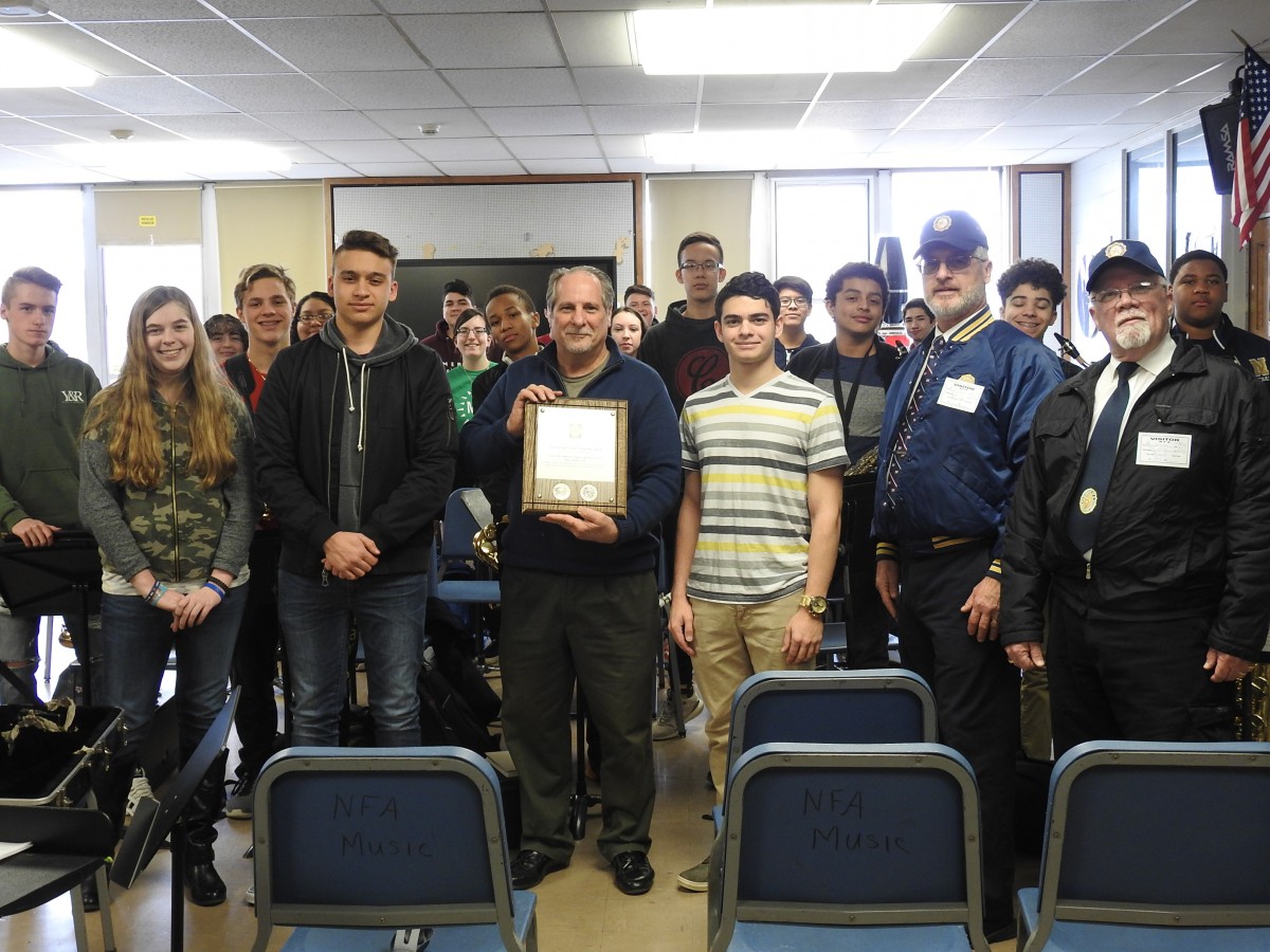 Mr. Zoutis pictured with the 鶹 Band and their plaque.