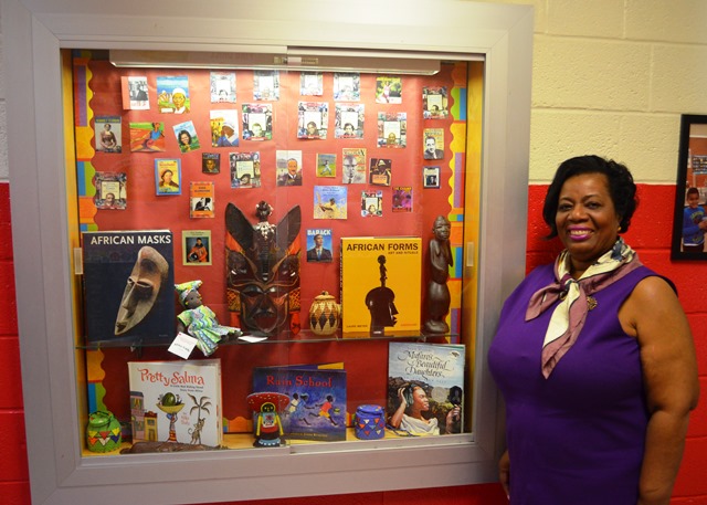 Beverley Johnson in front of display case.
