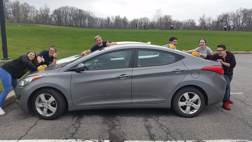 Students washing a car