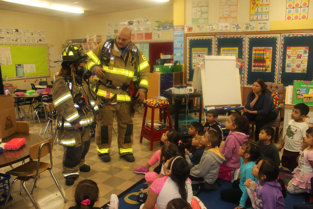 Another photo of firefighters in the classroom