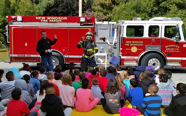 Firefighters talking to students