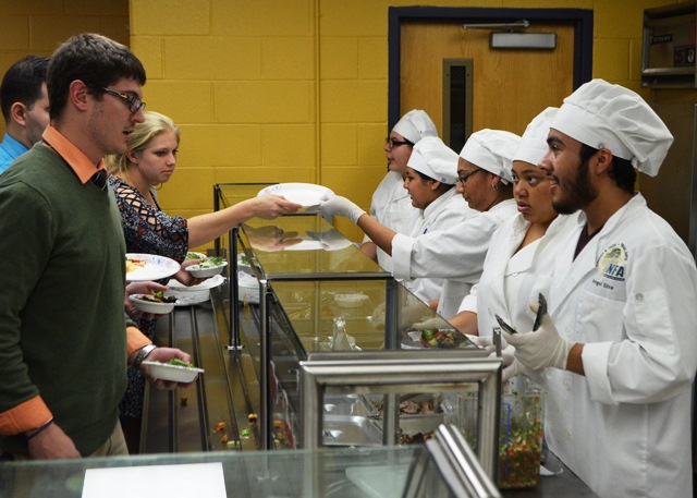 Students serving the reps dinner.