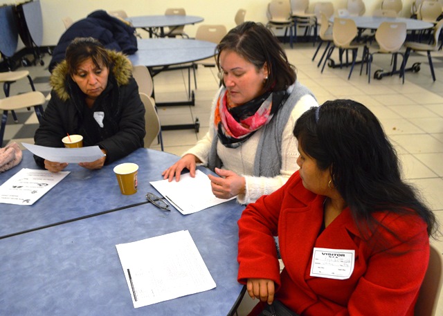 In small groups, parents discuss issue with the administrators