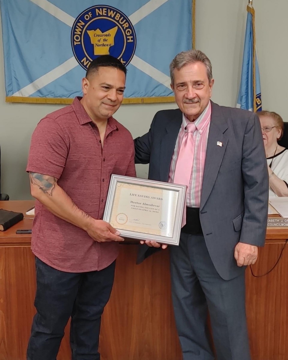 Hector Almodovar receives award from Town Supervisor Gil Piaquadio.