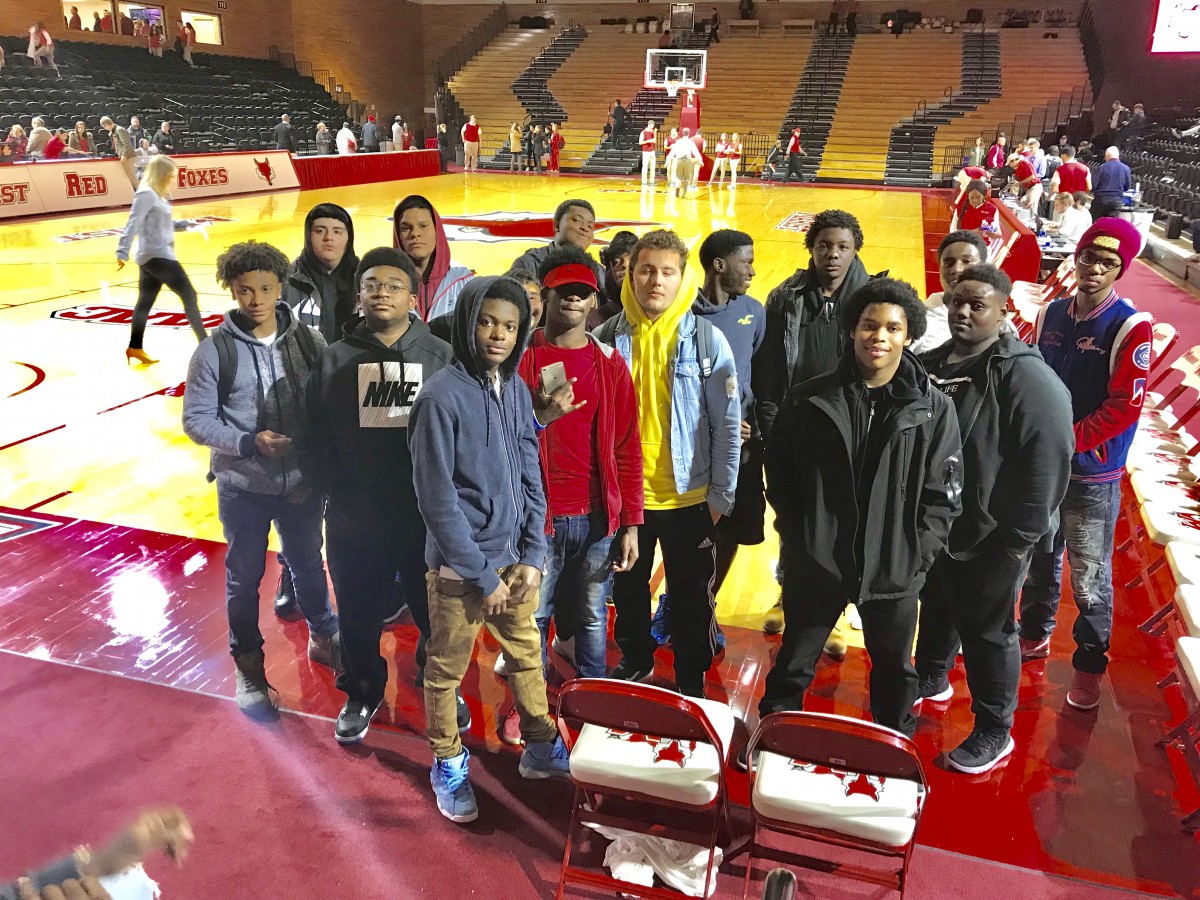 NFA West students pose on floor of Marist basketball court